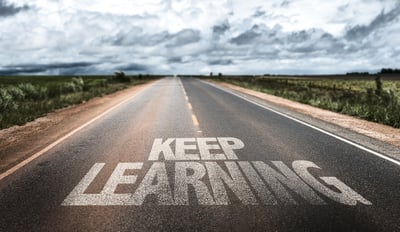 Keep Learning written on rural road